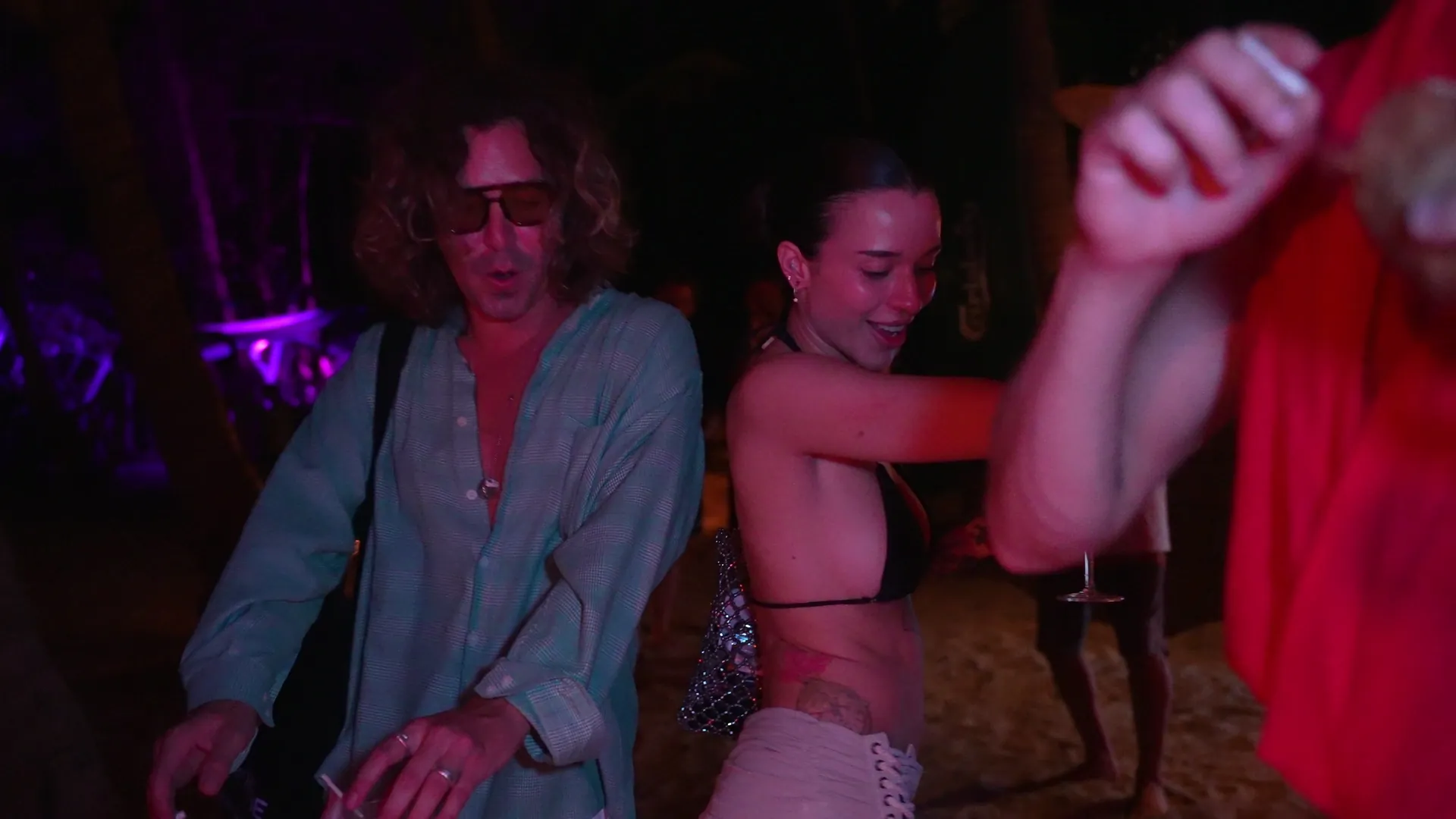 Guests dancing on the sand